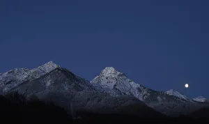 Images Dated 2014 February: The moon is seen over the mountain ahead of the womens parallel giant slalom competition