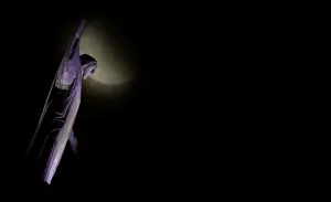 Latin America Prints: The moon is seen next to the statue of Christ the Redeemer during a total lunar eclipse