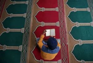 Religion Prints: A Muslim man reads the Koran inside a mosque during the holy month of Ramadan in