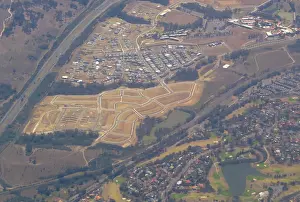 Newly constructed roads for a future housing estate can be seen near houses in western