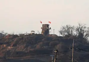: A North Korean flag flutters on the top of their guard post inside North Korean territory