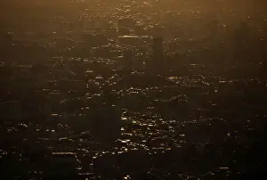 Office and residential buildings are silhouetted in the dusk from the observation