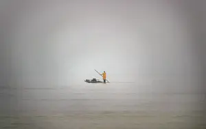 A Palestinian fisherman rows his fishing boat near the Jewish settlement of Shirat