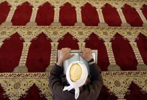 A Palestinian man reads the Koran in al-Aqsa Mosque, on the compound known to Muslims as A Palestinian man reads the Koran in al-Aqsa Mosque, on the compound known to Muslims as