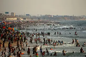 Palestinians bathe in the Mediterranean Sea as they escape from the summer heat, in