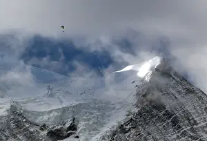 Weather Prints: A paraglider flies above the Bossons glacier in the Mont-Blanc massif on a sunny autumn