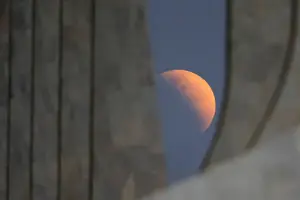 Latin America Prints: A partial lunar eclipse is seen outside the Planalto Palace in Brasilia