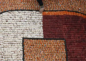 Participant arranges sushi to create mosaic during 10th anniversary of a sushi chain Participant arranges sushi to create mosaic during 10th anniversary of a sushi chain