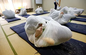 Participants perform Otonamaki, which translates as adult wrapping