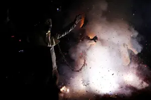 Taiwan Prints: Participants wearing motorcycle helmets get sprayed with firecrackers