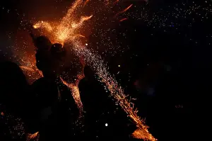 Taiwan Prints: Participants wearing motorcycle helmets get sprayed with firecrackers