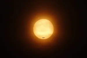 Malaysia Prints: A passenger jet flies past the setting sun in Shanghai