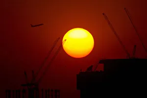 Images Dated 2012 September: A passenger jet flies past the setting sun in Shanghai