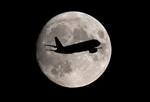 Trending: A passenger plane passes in front of the moon as it makes its final landing approach