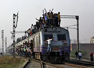 Trending: Passengers travel on an overcrowded train on the outskirts of New Delhi