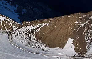 A patch of snow is covered for tourists to use with slides later in the season