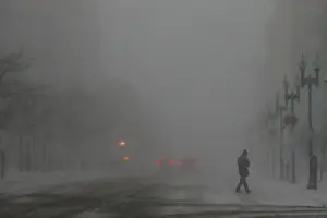 Weather Prints: A pedestrian crosses Boylston Street during a winter snow storm in Boston