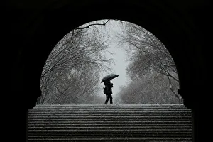 A pedestrian walks through Central Park during a snow storm in New York