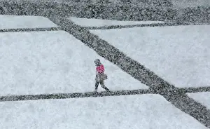 Prints of A pedestrian walks during a heavy snowfall in the Siberian town of Divnogorsk, Russia May 7, 2018. REUTERS/Ilya Naymushin Russia Prints: A pedestrian walks during a heavy snowfall in the Siberian town of Divnogorsk