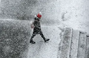 Weather Prints: A pedestrian walks during a heavy snowfall in the Siberian town of Divnogorsk