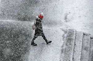 Weather Prints: A pedestrian walks during a heavy snowfall in the Siberian town of Divnogorsk