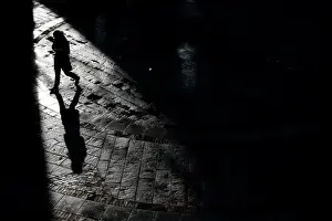 Weather Prints: A pedestrian walks through Quincy Market on a warm winter afternoon in downtown in Boston