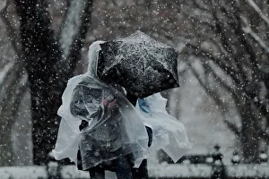 Weather Prints: Pedestrians walk through Central Park during a snow storm in New York