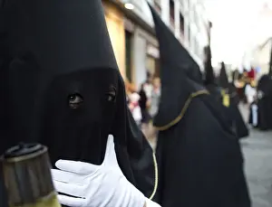 Spain Prints: A penitent waits for the start of a procession in Tenerife in Spains Canary Islands