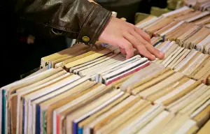 People browse books at secondhand partition with old newspapers