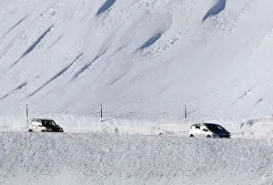 Weather Prints: People drive their cars slowly on a snow-covered road in Saint-Pancrace as winter weather
