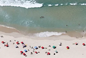 People enjoy the Barra da Tijuca beach in Rio de Janeiro