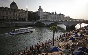 People enjoy the sun as Paris Beach opens along the banks of River Seine in Paris
