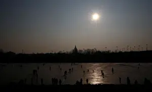 Weather Prints: People enjoy a sunny winter day on the frozen New Danube river in Vienna