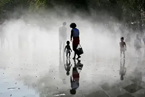 France Prints: People gather near fountains of water as they cool off at the Miroir d Eau