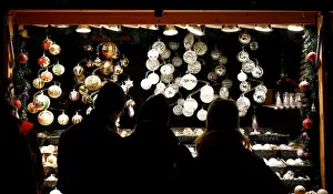 Christmas Prints: People look at Christmas decorations at a Christmas market in front of the Schoenbrunn