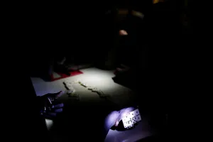 Storm Prints: People play dominoes in a partially destroyed school used as a shelter after Hurricane