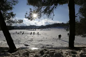 People play with snow after a heavy snowstorm in Amman