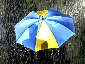 PEOPLE SHELTER UNDER UMBRELLAS AS TORRENTIAL RAIN FALLS IN LONDON