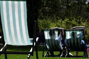 Prints of People are silhouetted against the farbric of deckchairs as they enjoy the sunshine in St James Park in London, Britain, April 18, 2018. REUTERS/Toby Melville Britain Prints: People are silhouetted against the farbric of deckchairs as they enjoy the sunshine in St