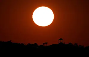 Sunlight Prints: People are silhouetted against the setting sun at El Mirador de la Alemana in Malaga