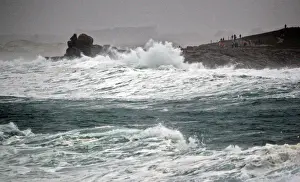 France Prints: People standing on the Pointe de la Torch peninsula watch waves breaking on the Brittany