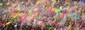 People throw coloured powder during the Holi festival in Barcelona