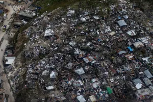 People wade through a flooded street and next to destroyed houses after Hurricane Matthew People wade through a flooded street and next to destroyed houses after Hurricane Matthew