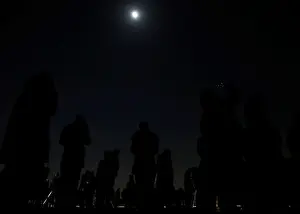 : People wait to watch a lunar eclipse at the open air skydeck of Roppongi Hills Tower in
