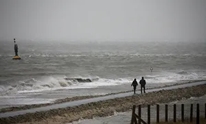 Prints of People walk on a beach at the North Sea in Cuxhaven, December 5, 2013. A storm named Xaver is expected to hit the northern coast of Germany on Thursday, bringing strong winds and high tides Germany Prints: People walk on a beach at the North Sea in Cuxhaven