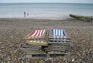 United Kingdom Prints: People walk their dog, in light rain, on the empty beach of the south coast holiday