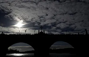 Czech Prints: People walk across the medieval Charles Bridge in Prague