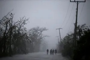 Storm Prints: People walk on the road as rain falls during Hurricane Matthew in Les Cayes, Haiti