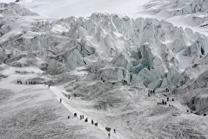 People walk along the slopes of the Cayambe volcano