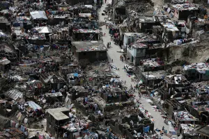 People walk on a street next to destroyed houses after Hurricane Matthew hit Jeremie People walk on a street next to destroyed houses after Hurricane Matthew hit Jeremie